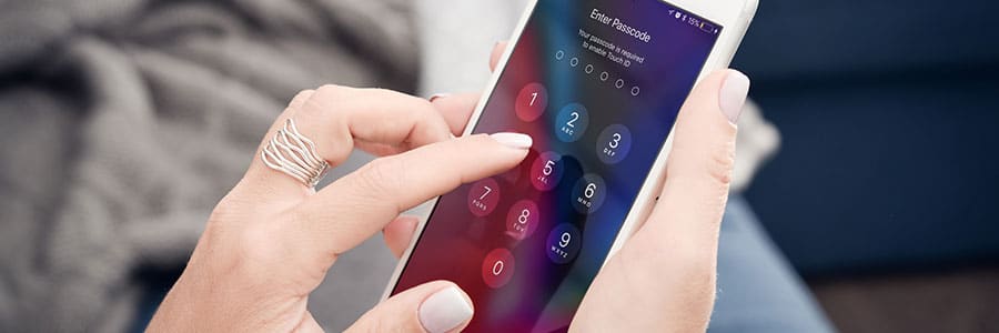 Person entering their passcode on their iPhone