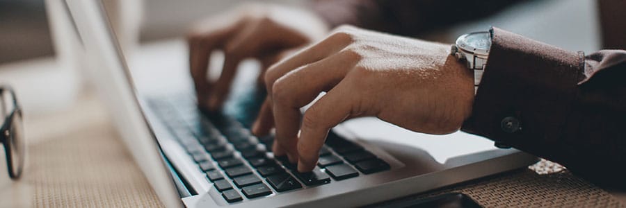 Business person typing on a laptop