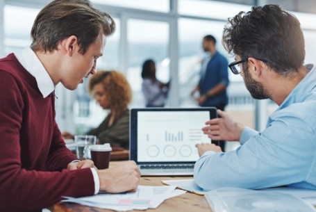 IT professionals looking at data on a computer