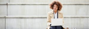 Woman working on her laptop in the park