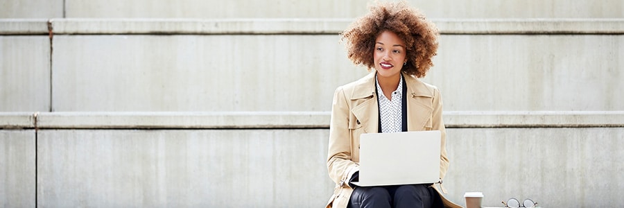 Woman working on her laptop in the park
