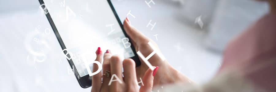 Woman typing on her tablet
