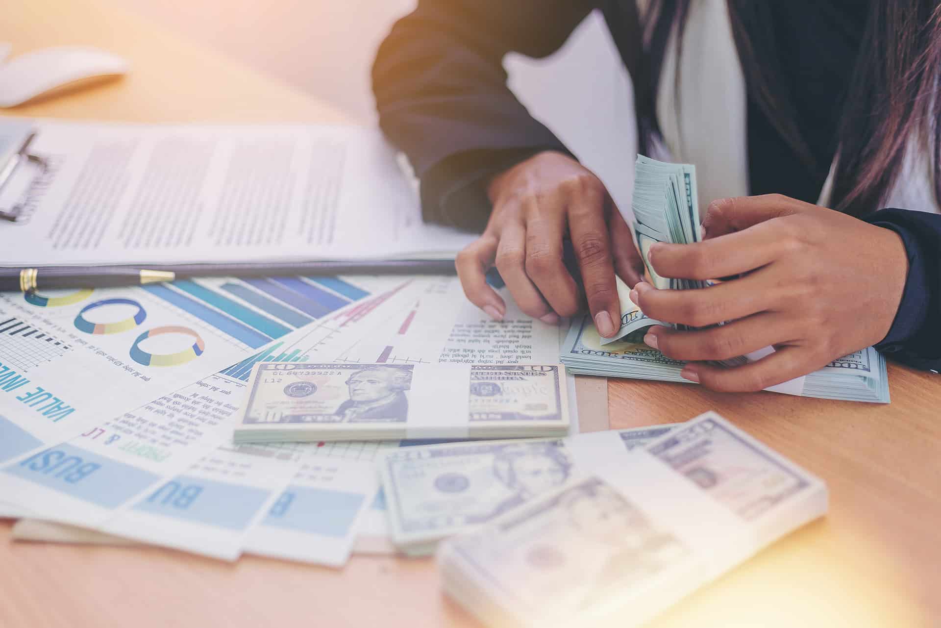 Woman counting money at a bank