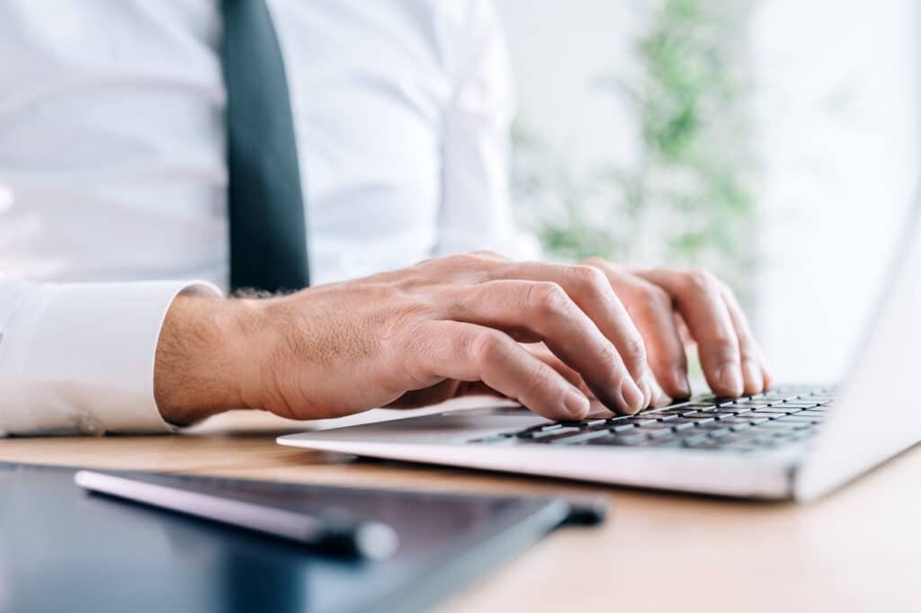 banker on laptop trying to protect against cybersecurity threats