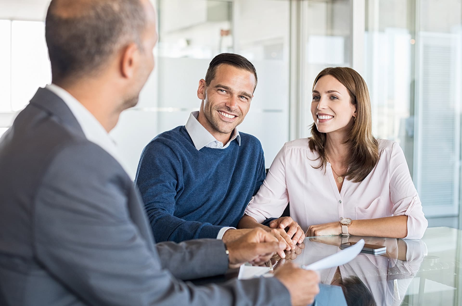 Happy couple talking with businessman