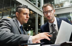 employees discussing cloud usage on laptop