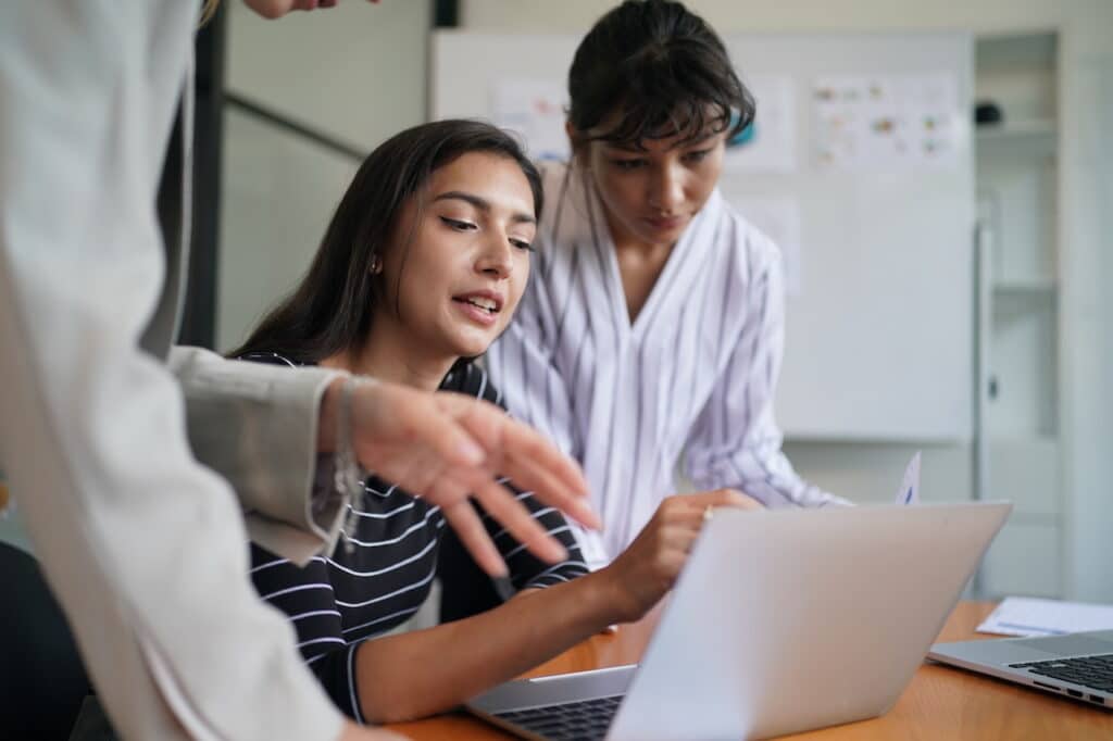 employees at computer discussing business continuity solutions