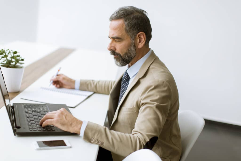 bank employee on aging computer