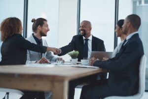 group of bank employees with one shaking vendors hand